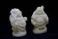 white coloured Loughing Buddha with black background