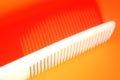 A white comb with yellow background and shadow Royalty Free Stock Photo