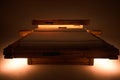 White comfortable mattress on a wooden frame, front view.