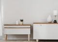 White commode with table lamp in bright minimalism interior style Royalty Free Stock Photo