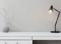 White commode with table lamp in bright minimalism interior style