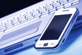 White communicator on silver laptop. Blue tint. Royalty Free Stock Photo