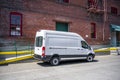 White compact popular cargo mini van for local deliveries and business standing on the warehouse parking lot Royalty Free Stock Photo