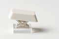 White computer enter key side profile close up with scissor mechanism visible on a clear acrylic riser on white Royalty Free Stock Photo