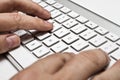 White computer keyboard with hands Royalty Free Stock Photo