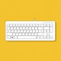 White computer keyboard on a yellow background. QWERTY layout with function keys, Royalty Free Stock Photo