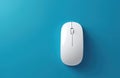 White computer mouse on a blue background. Minimalist photo of a modern digital device used for navigation and control. Simple Royalty Free Stock Photo