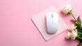White computer mouse on pink mousepad with roses on a pink background Royalty Free Stock Photo