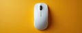 White computer mouse rests on vibrant orange background. Sleek modern device for digital interaction and productivity. Simple Royalty Free Stock Photo