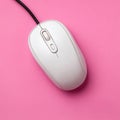 White computer mouse on a vibrant pink background. Royalty Free Stock Photo
