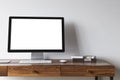 White computer screen on a dark wooden desk Royalty Free Stock Photo
