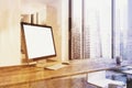 White computer screen on a wooden desk side toned Royalty Free Stock Photo