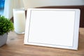 White computer tablet with isolated screen on table in cafe Royalty Free Stock Photo
