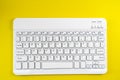 White Computer wireless Keyboard on Yellow Background Royalty Free Stock Photo