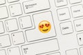 White conceptual keyboard - Key with Heart eyes Emoji symbol