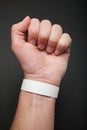 White concert paper bracelet on hand, mockup. Wristband accessory adhesive