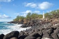 White concrete lighthouse on rocky Hawaii shore Royalty Free Stock Photo