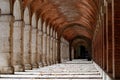 arched passageways are lined with white concrete pillars and brick arches Royalty Free Stock Photo