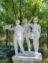 White concrete sculpture of three Soviet pioneers in Ukraine.