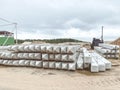 White concrete structures lie on wet ground. building material for the construction of the foundation. construction site of an