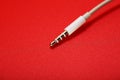 White connector AUX white cable on a red background Royalty Free Stock Photo