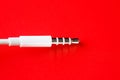 White connector AUX white cable on a red background Royalty Free Stock Photo