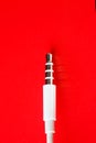 White connector AUX white cable on a red background Royalty Free Stock Photo