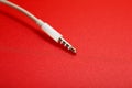 White connector AUX white cable on a red background Royalty Free Stock Photo