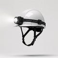 White construction helmet with headlamp turned on black strap falling, isolated on white Royalty Free Stock Photo