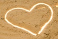 White contour heart in the sand