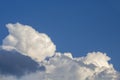 White contrasting clouds backlit by the sun on a blue summer sky. Background. Royalty Free Stock Photo