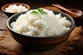 White cooked rice in a brown wooden bowl on a wooden table. Generated by artificial intelligence Royalty Free Stock Photo