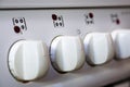 White cooker buttons in a row with numbers