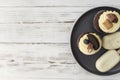 Muffins and cupcakes on tray. Cookie ice creams on a stick. Wooden background Royalty Free Stock Photo