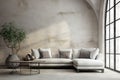 White corner fabric sofa against arched window near grunge aged stucco wall. Interior design of modern living room