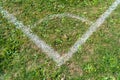 White corner lines on empty soccer grass field