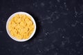 White cornflakes bowl on dark background. Concept Top View