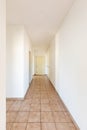 White corridor with tiles and closed doors Royalty Free Stock Photo