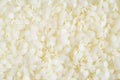 White cosmetic beeswax pellets background.