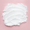 White cosmetic foam texture on pink on pink background. Cosmetic mousse, cleanser, shaving foam, shampoo. Foamy skin care product Royalty Free Stock Photo