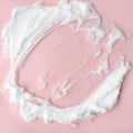 White cosmetic foam texture on pink on pink background. Cosmetic mousse, cleanser, shaving foam, shampoo. Foamy skin care product Royalty Free Stock Photo