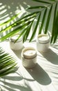 White Cosmetic Jars on a Table With Tropical Plant Shadows and Sunlight