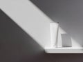 White cosmetic tube and rectangular object on white shelf isolated on white background Royalty Free Stock Photo