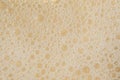 White cosmetics foam texture on beige background. Cleanser, shampoo bubbles, wash - liquid soap, shower gel, shampoo Royalty Free Stock Photo