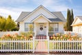 white cottage with a picket fence and climbing roses Royalty Free Stock Photo