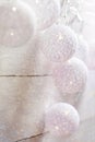 White Cotton Balls Garland Hanging on Wood Wall. Scandinavian Style. Glittering Lights. Christmas Decoration. New Year. Pastel Col