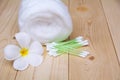 White cotton bud with cotton roll and white flower over wooden t Royalty Free Stock Photo