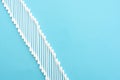 White cotton buds lie in a row on a blue background Royalty Free Stock Photo