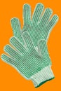White Cotton Gloves With green Rubber Studs On orange Royalty Free Stock Photo