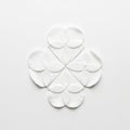 White cotton pads arranged in a circular pattern, creating a symmetrical, geometric design on a Royalty Free Stock Photo